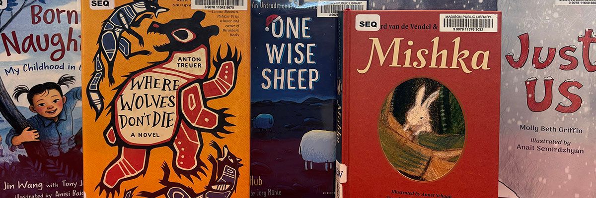 A collection of children's books are displayed overlapping.