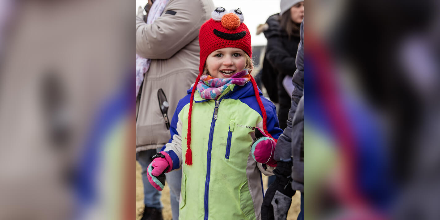 Child in a winter coat enjoys Frosty Fun
