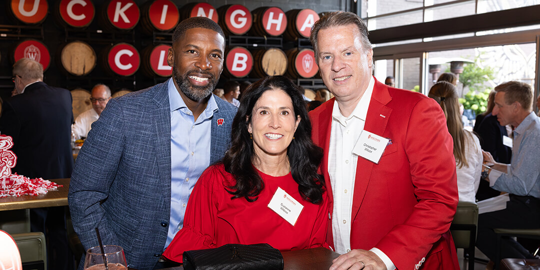 Deputy athletic director Marcus Sedberry celebrates with committee members Chris Wilcox ’91 and Suzanne Wilcox.