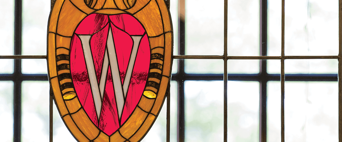 A stained glass UW crest adorns a campus window.