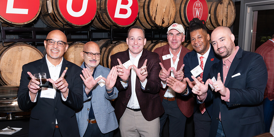 Buckingham Club committee members and guests throw the “W” with speaker Dr. Sanjay Asthana.
